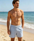 Man wearing 5 Inch Quick Dry Swim Trunks For Guys With Stretch Fabric And Zip Pockets Lightweight Beach Shorts, Blue White Stripe