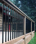 Built Tough Metal Round Baluster Railing Post For Stairway Banisters And Deck Fences With No Sweat Ground Mount Setup For Straight Lines Or Tight Spiral Angles, showing black iron posts on wooden railing.