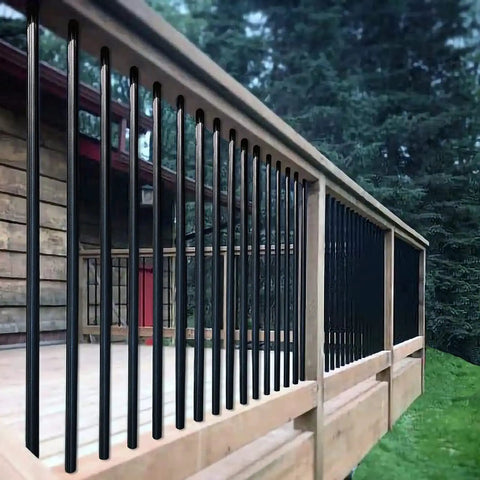Built Tough Metal Round Baluster Railing Post For Stairway Banisters And Deck Fences With No Sweat Ground Mount Setup For Straight Lines Or Tight Spiral Angles, showing black iron posts on wooden railing.