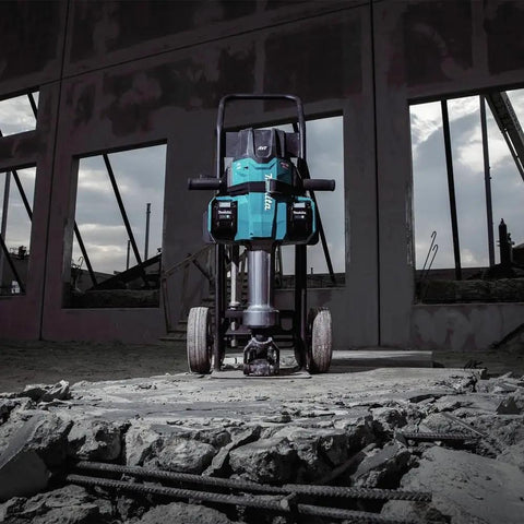 Badass Heavy Duty Eighty Volt Brushless Cordless Breaker Hammer With Seventy Foot Pounds Of Knockout Chisel Power positioned on rubble.