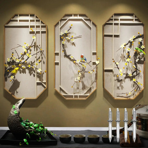 Decorative wall art with three panels featuring birds and flowering branches, showcasing intricate design and craftsmanship.