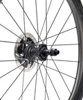 Close-up of a bike wheel hub with heavy duty bike quick release axle skewer set for front and rear hollow shaft kit replacement.
