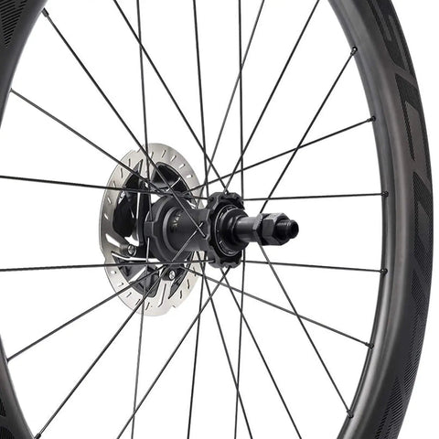 Close-up of a bike wheel hub with heavy duty bike quick release axle skewer set for front and rear hollow shaft kit replacement.