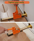 Orange hardwood flooring jack installation tool with long ratcheting screw bar for tongue-and-groove planks