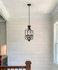 10.63 Inch Black Farmhouse Chandelier With Four Lights Modern Industrial Lantern Pendant Light Fixture in a hallway setting