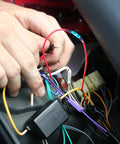 Heat shrink butt connector on red wire in car wiring harness; blue shrink sleeve visible.