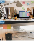 Office and home desks with stationery and laptops showcasing desk organization for cable management solutions.