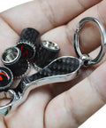Porsche Dope Carbon Fiber Valve Stem Caps 4 Pack With Resin Red S Emblem Trim Rotates 360 Degrees shown with keychain on hand