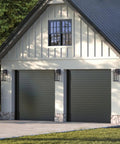 Boxwood Collection 1-Light Outdoor Wall Lantern With Clear Seeded Glass, Antique Bronze Finish on garage exterior.