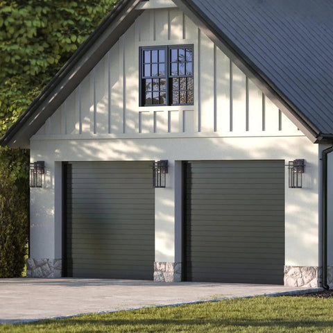 Boxwood Collection 1-Light Outdoor Wall Lantern With Clear Seeded Glass, Antique Bronze Finish on garage exterior.