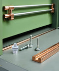 50 Pcs M5 T Slot Nuts Sliding Blocks Set For Woodworking And Milling shown near green cabinet with copper rails
