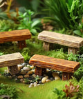 Miniature Bench Set Resin Faux Wood Six Piece for Crafts Micro Landscape Dollhouse and Fairy Garden Accessories 2.20 Inch Cute Tiny Outdoor Decor for DIY Projects displayed in a mossy fairy garden.