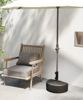 Beefy Heavy Duty Water Or Sand Fillable Patio Umbrella Base Stand With 73 Pound Weight Wall Mounted next to a chair in garden