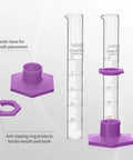 Durable Pro Grade Borosilicate Glass Measuring Cylinder Set With Hex Base And Brush Includes 10 ML 25 ML 50 ML And 100 ML Cylinders Class B Lab Glassware For Chemistry Experiments And Education; shown with purple hex base and anti-tipping ring details.