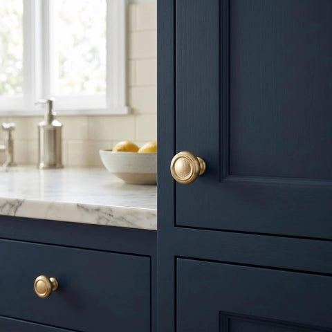 Set Of Six Champagne Bronze Cabinet Knobs In Zinc Alloy Modern Hardware on dark blue cabinet drawer with marble counter