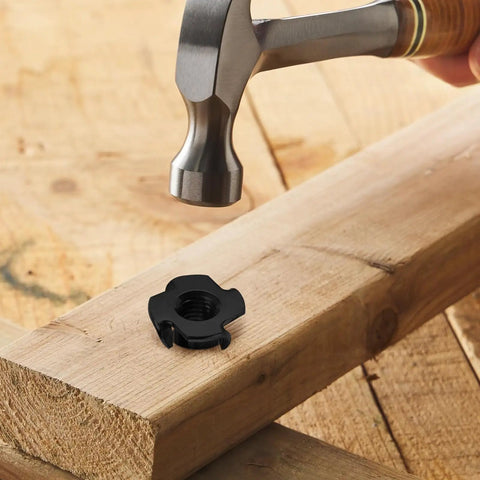 5/16-18 Tee Nuts Four Pronged Black Zinc Plated Steel For Wood And Furniture Projects shown with hammer and wood