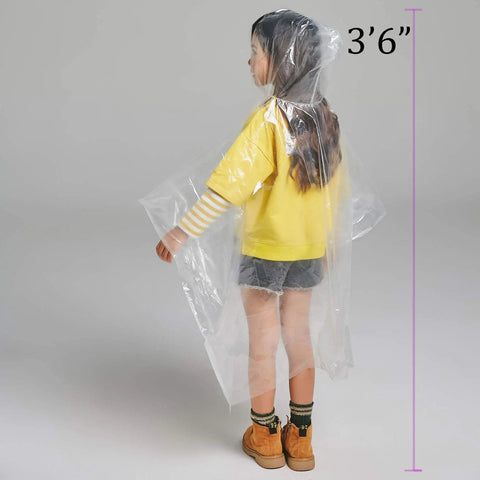 Child wearing clear plastic rain poncho with hat rope, 3'6" tall, from Six Pack Kids Disposable Rain Ponchos Fifty Percent Thicker Emergency Rain Gear Clear Plastic Ponchos With Hat Rope To Keep Heads Dry Durable Yet Lightweight For Outdoor Play And School Trips