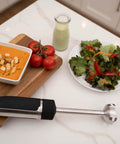 Professional Grade Commercial Blending Machine With A Badass 1800 Watt Motor and Dead Simple Variable Speed Settings on countertop with soup and salad.