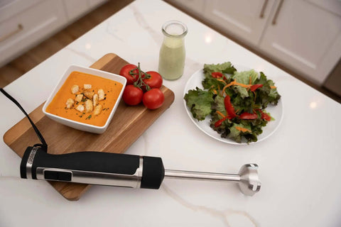 Professional Grade Commercial Blending Machine With A Badass 1800 Watt Motor and Dead Simple Variable Speed Settings on countertop with soup and salad.