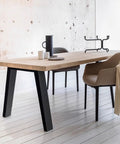 Built Legit Tough 30 Inch Heavy Duty Steel Table Legs With Wide Industrial Crossbar DIY Black Metal Furniture Base For Desks Dining Tables And Garage Workbenches supporting a wooden table in a minimalistic setting.
