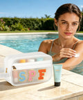 Woman by pool using cream with Clear SPF Sunscreen Bag With Handle For Beach And Pool, Waterproof See-Through Travel Toiletry And Makeup Bag