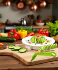 Green spiral slicer with white base on wooden cutting board, cucumber rounds and spiral slices.