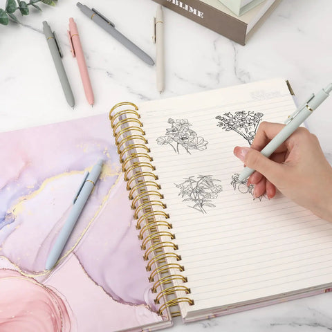 Pack Of Six Smooth Writing Retractable Gel Pens Featuring Snappy Click Mechanism And Fast Drying Black Ink That Rolls Dead Smooth Across Pages Ideal For Classroom Assignments Desk Organization And Daily Note Taking Without Any Smudging on a notebook with sketches.