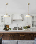 Top Shelf Matte White Farmhouse Pendant Light With Burnished Brass Accents and Super Adjustable Chain over modern kitchen island.