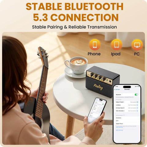 Compact 10W Bluetooth Guitar Amp For Practice With Dual Clean And Distortion Channels on table next to smartphone