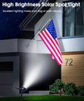 Multicolor Solar Lights Outdoor Pack Of 4 With 18 LEDs Waterproof Landscape Spotlights illuminating flag at night
