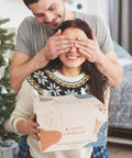 Smiling woman holding Beginner Friendly DIY Soy Candle Making Kit with Melting Pot, 10 Jars and Tins in giftable box.