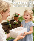 Mother and child in garden with gift box for Kid Friendly Hands On Garden Tool Set For Toddlers With Pink Tote Bag Apron