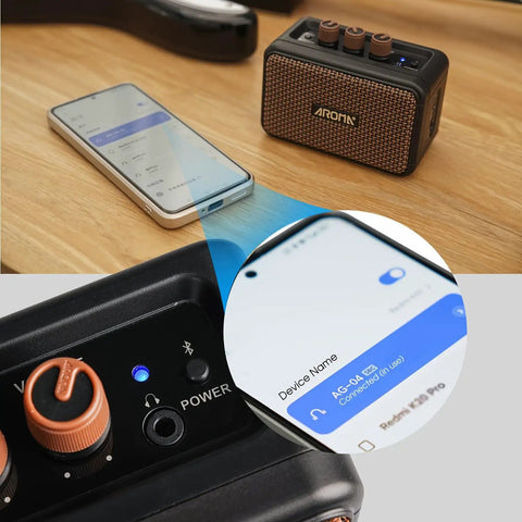 Aroma Mini 5W Guitar Amp With Clean And Overdrive Channels, Rechargeable Portable Electric Guitar Amp AG 04 next to smartphone