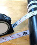 16-Foot Flatback Tape Measure With Left Or Right Readability, Go-To Standby PS-FLAT16 wrapped around cylinder, black casing