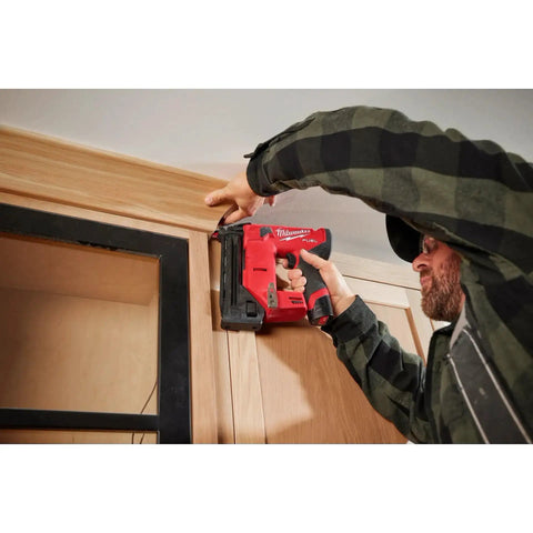 Worker using M12 Fuel 18 Gauge Compact Brad Nailer With Tool Free Depth Adjustment Jam Clearing Latch Sequential And Contact Actuation