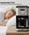 14-Cup Programmable Drip Coffee Maker With Normal And Strong Brew For Home Or Office, Glass Carafe, on a bedside table