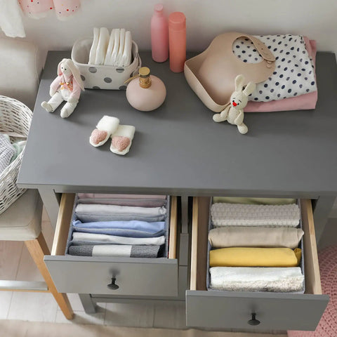 Wardrobe closet organizers drawers with folded clothes, stuffed toys, baby items on top, neat and tidy storage setup