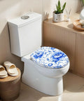 Elongated Blue Peony Floral Chinoiserie Elegant Porcelain Toilet Seat on a white toilet, featuring a soft-close hinge.