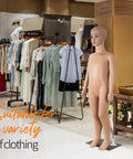 Child-sized full-body mannequin with bald head on metal base in clothing store display.