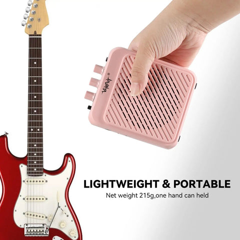 Mini 3W Rechargeable Bluetooth Guitar Amp With Dual Channel Clean And Overdrive For Indoor Practice And Travel, portable pink amp held in hand next to guitar.