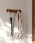 Flip Wall Mounted Coat Rack With Retractable Hooks Do-It-All Modern Space Saving Hallway Organizer in use with coat and umbrella