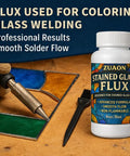 Bottle of 8oz Water Based Liquid Flux For Stained Glass And Electronics Soldering With Brush on desk next to stained glass.