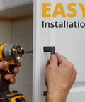 Installing Matte Black Cabinet Pulls 25 Pack, 5.5 Inch Length With 5 Inch Hole Spacing on a white cabinet door with a screwdriver.