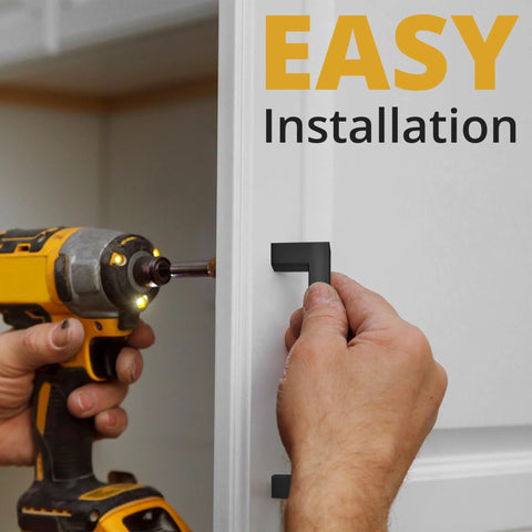 Installing Matte Black Cabinet Pulls 25 Pack, 5.5 Inch Length With 5 Inch Hole Spacing on a white cabinet door with a screwdriver.