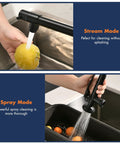 GIMILI Matte Black Commercial Kitchen Faucet with Pull Down Sprayer in stream mode washing a yellow lemon and spray mode cleaning vegetables.