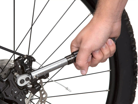 Using One Quarter Inch Drive Dual Direction Click Torque Wrench Ten To One Hundred Fifty Inch Pounds Range on bike wheel