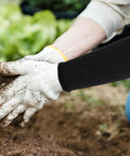 Anti Cut Black Arm Sleeves With Elastic Bands worn while gardening, protecting forearms from dirt and debris.