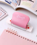 Adjustable 6 Hole Punch for diary planner and binder pages, 5.5mm round holes, shown with pink design, ideal for A5 A6 A7 paper
