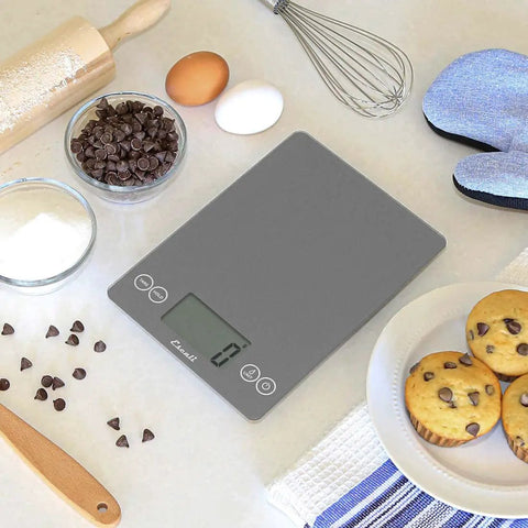 Glass Digital Kitchen Scale With 15 Pound Capacity, Big Backlit Display, Easy Touch Controls on kitchen counter with baking items