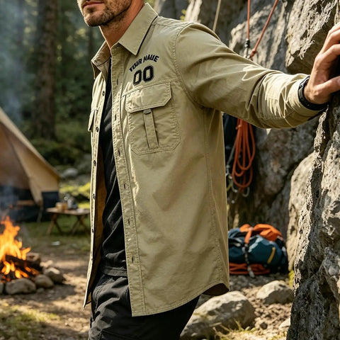 Toolbox Tested Custom Long Sleeve Work Shirt For Men Quick Dry Button Up Mechanic Uniform Personalized Utility Top Heavy Duty Green Wicking Fabric For The Daily Grind. Model outdoors by fire wearing khaki shirt.